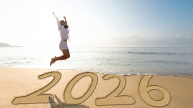 Vrouw springt op het strand voor het nieuwe jaar 2026