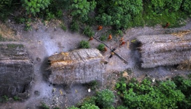 Handout photo shows members of an unknown Amazon Basin tribe and their dwellings during a flight over the Brazilian state of Acre along the border with Peru
