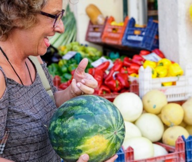 Senior women buying a watermelon in in the Corfu town