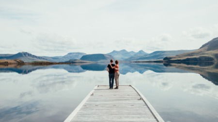 Koppel staat op de steiger van een meer in IJsland, het meest vreedzame land ter wereld in 2025