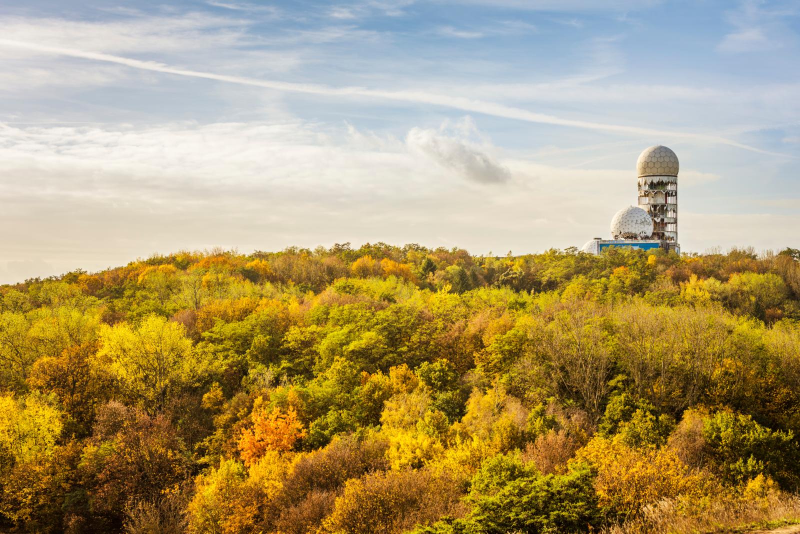 Teufelsberg in Berlijn, met vervallen radarstations boven op een beboste heuvel.