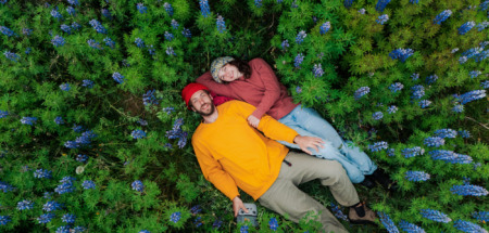 Man en vrouw liggen tussen de bloemen in IJsland, het vreedzaamste land ter wereld in 2026