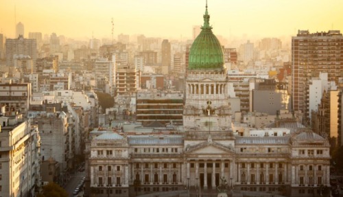 Uitzicht op het Congresgebouw van Buenos Aires met groene koepel bij zonsondergang.