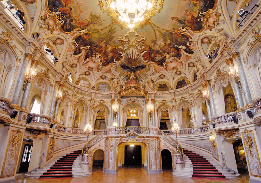Interieur van de balzaal in het Kurhaus Wiesbaden met rijk versierde plafonds en trappen.