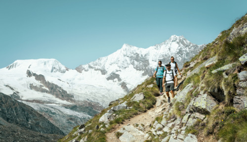Drie hikers in de bergen van Saasfee