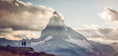 Twee hikers kijken uit op de Matterhorn in Wallis, Zwitserland