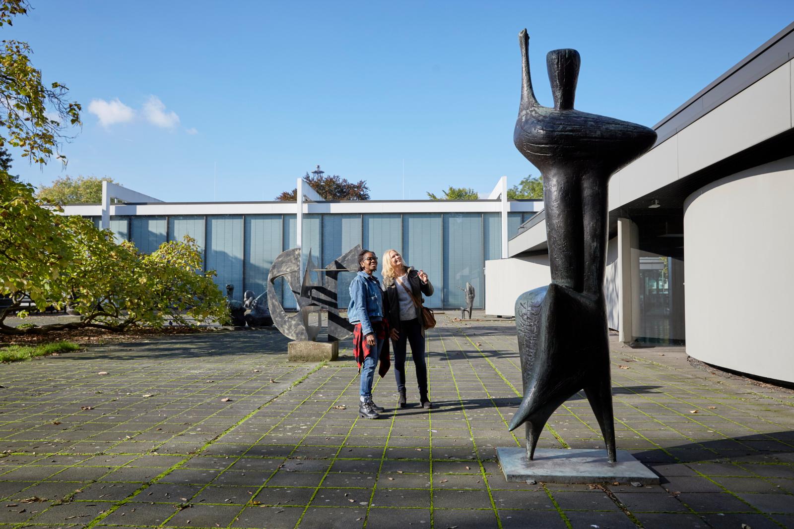 Bezoekers tussen moderne sculpturen in het Skulpturenpark bij het Lehmbruck Museum in Duisburg.