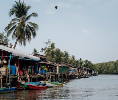 raditioneel vissersdorp met houten huizen en boten langs een waterweg in de Cardamom Mountains in Cambodja