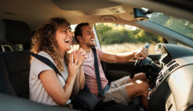 Young couple shares lighthearted moments and laughter during their adventurous car journey