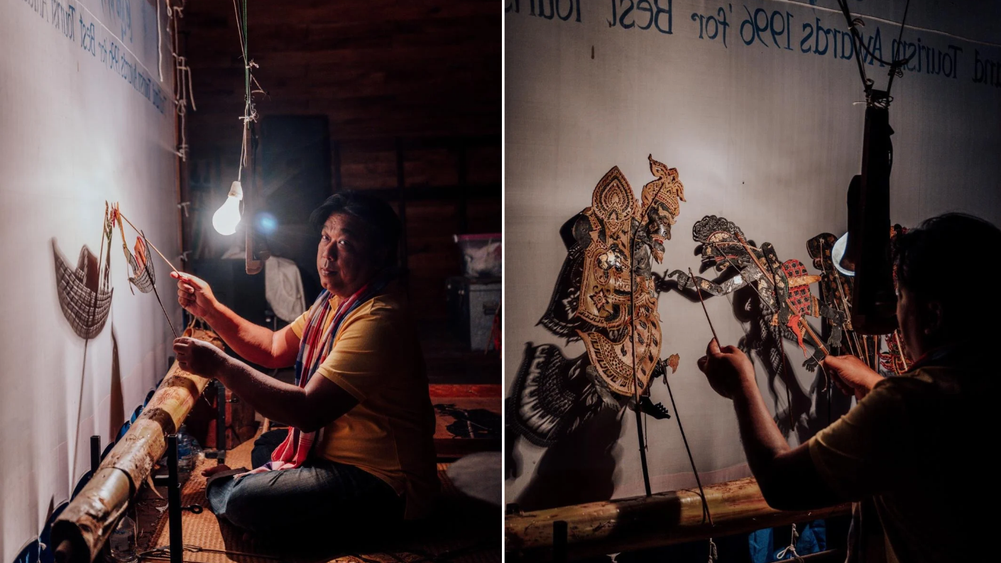 Man demonstreert Nang Talung, het traditionele Thaise schaduwspel met handgemaakte figuren voor een verlicht doek.