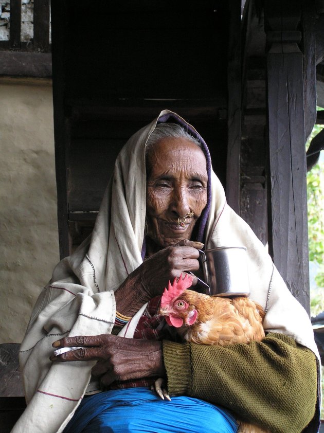 Oude vrouw met haar kip