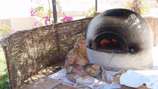 Dame die traditioneel Egyptische brood aan het bakken is