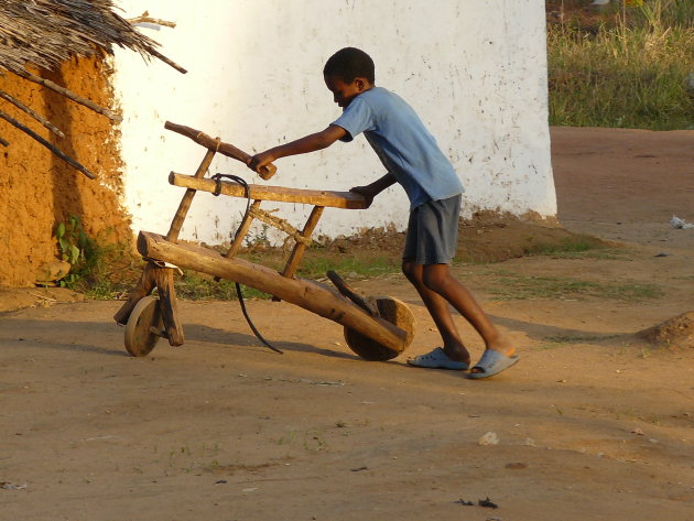 Spelen met de zelfgemaakte houten fiets.
