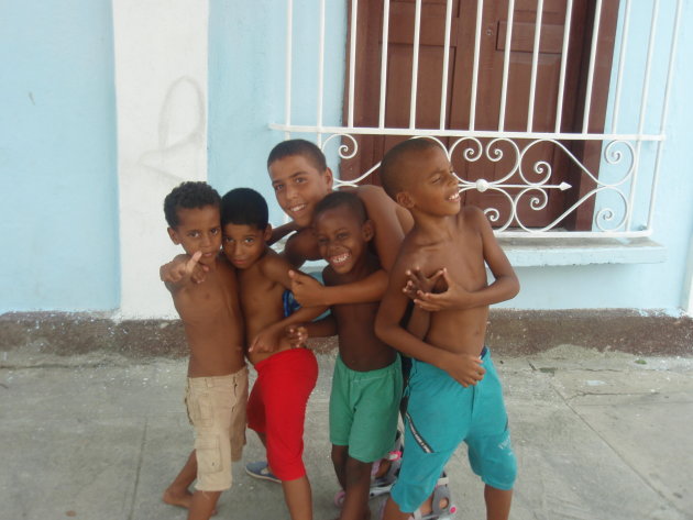 Een aantal jongetjes spelen voetbal op straat en poseren voor de foto