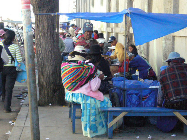 Altiplano, Cholita wth baby at market, lunchtime